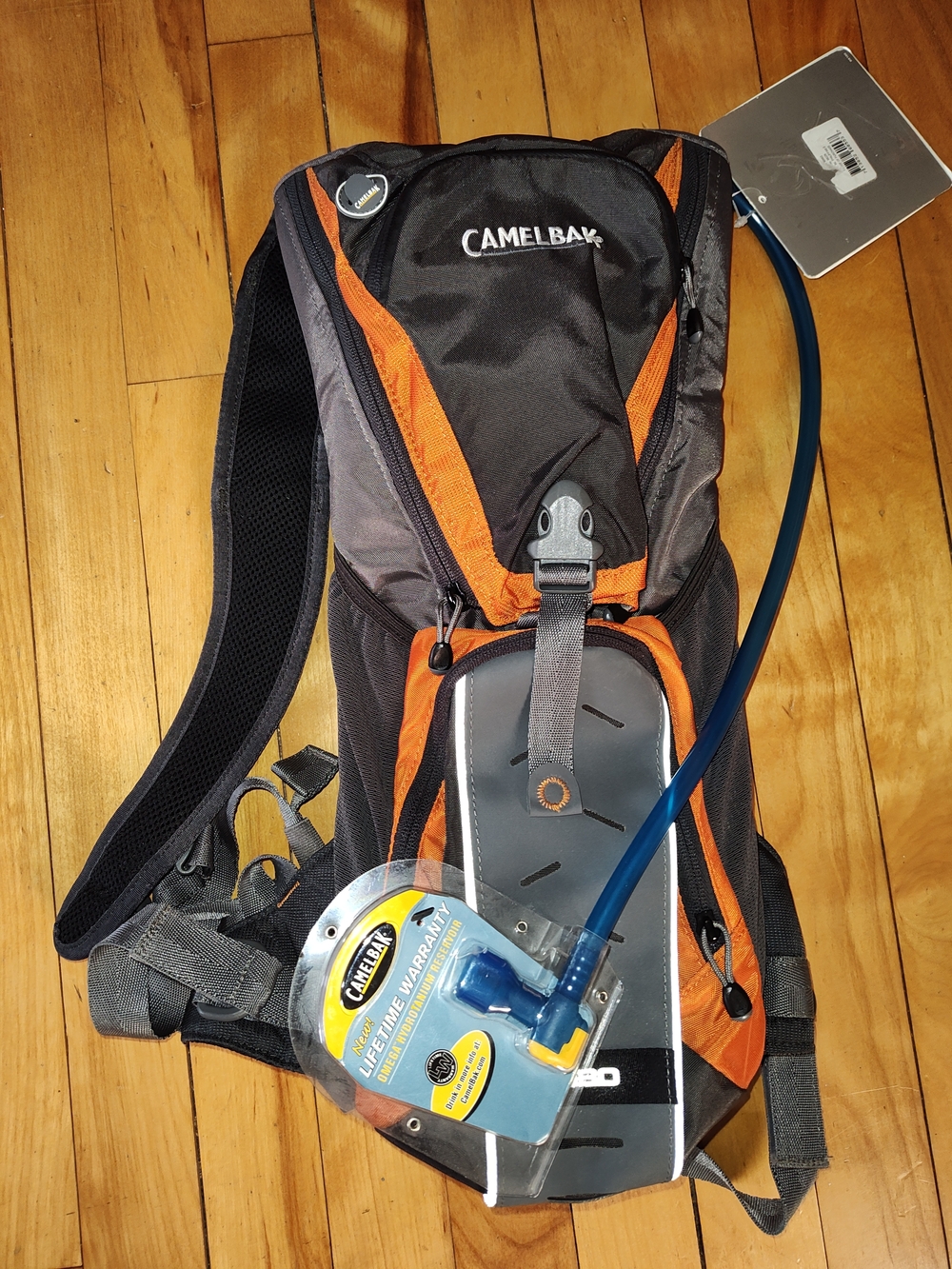 CamelBak Black and Orange Hydration Pack with Blue Tube